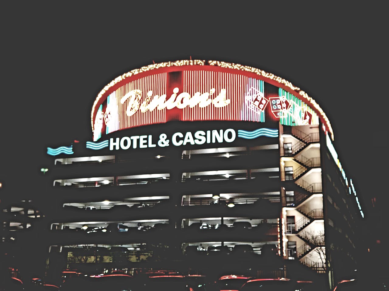 heros-img Night view of the iconic Binion's Hotel and Casino showcasing its bright neon lights in Las Vegas.